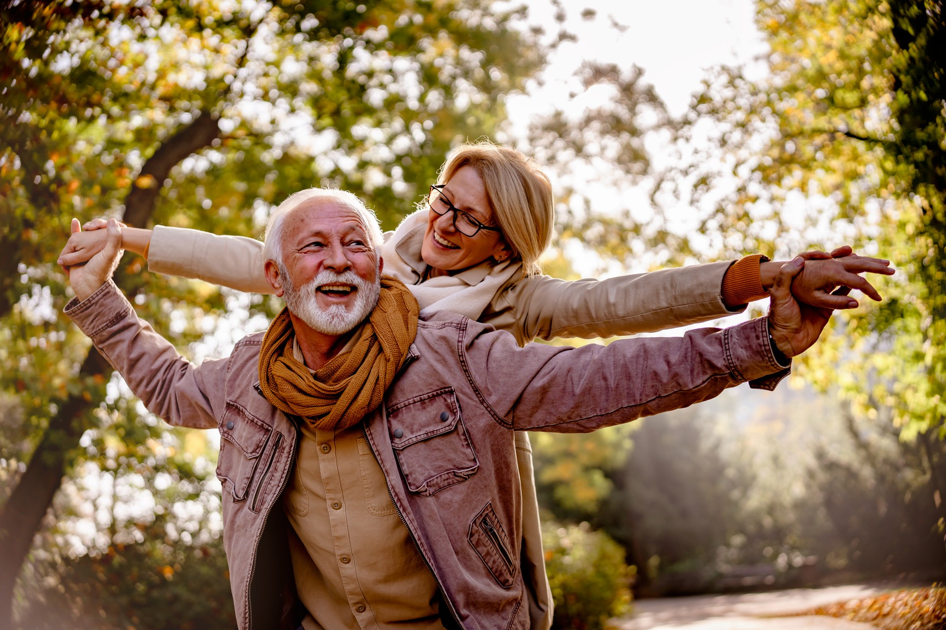 Cheerful pensioners enjoying their life together having fun outdoors in the park